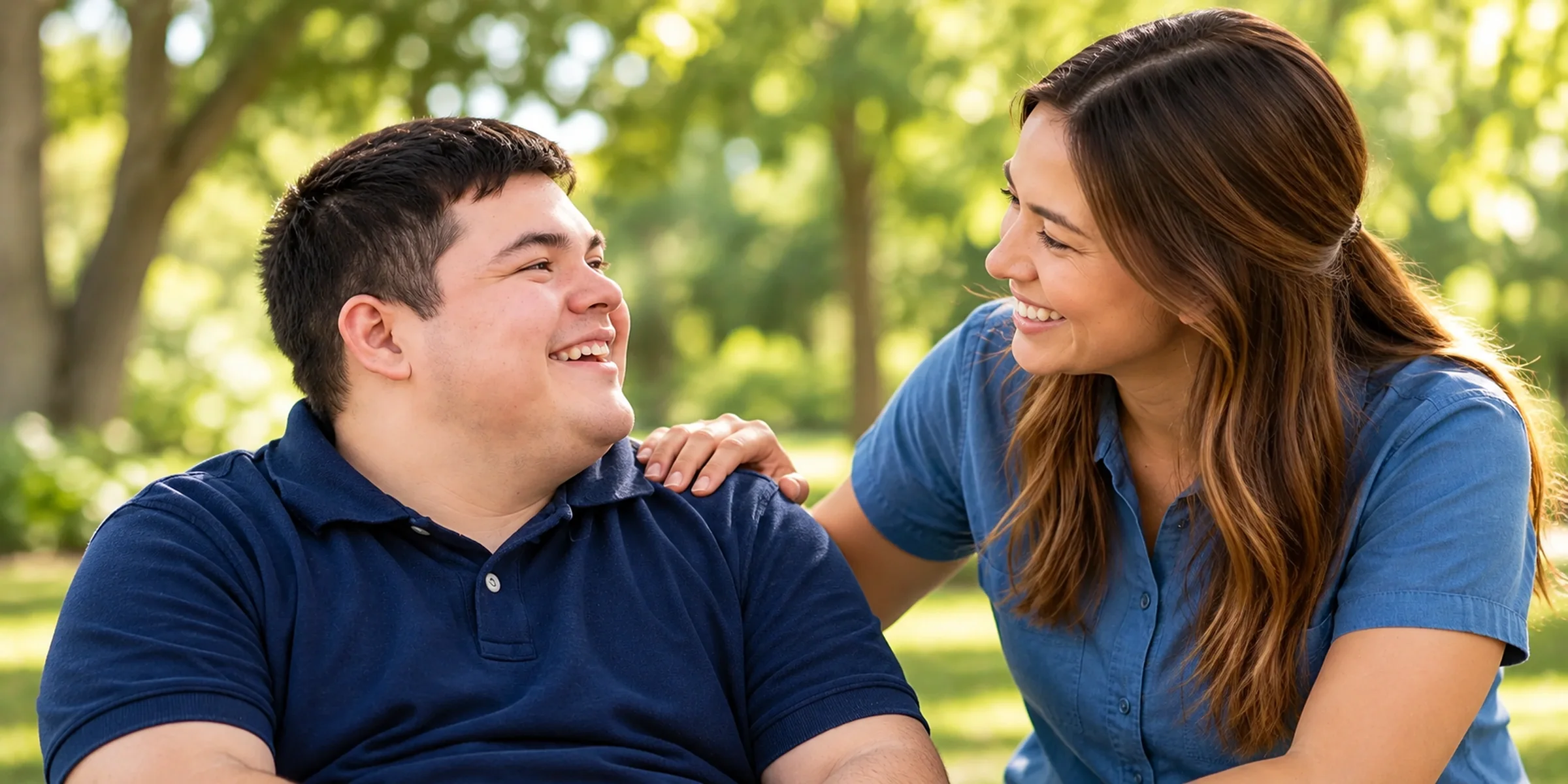 A support worker sharing a smile with a participant outdoors